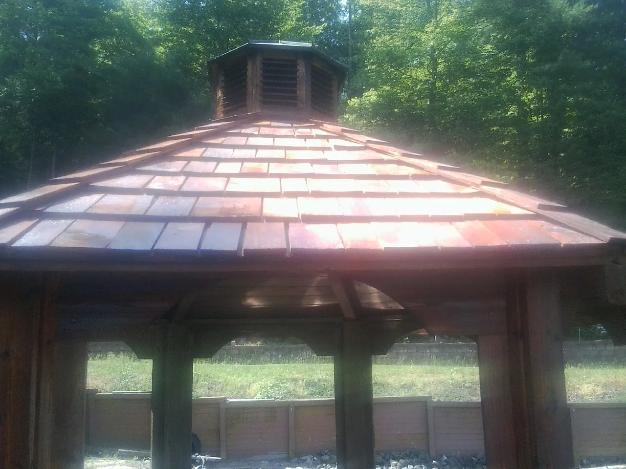 New cedar shake roof and cupola on a lakeside gazebo in Grabill
