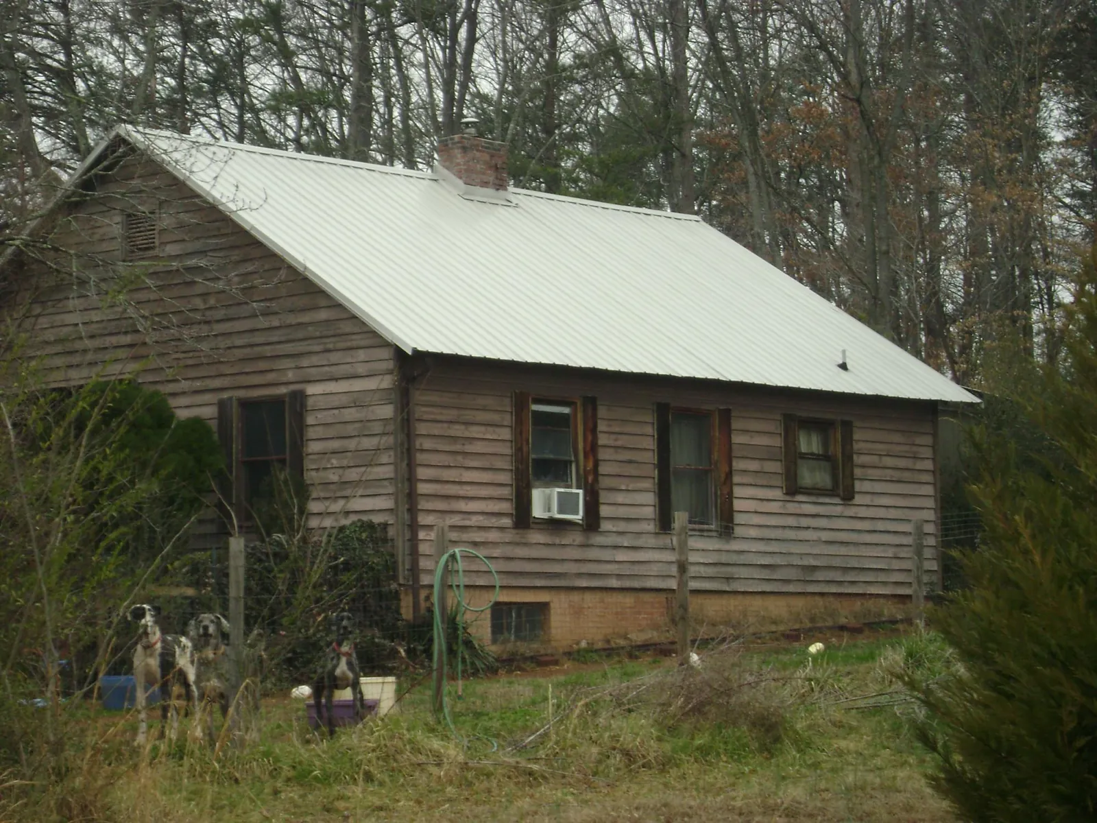 White metal roof on an old wood sided farmhouse, from a Metal Roof Installation job in Grabill